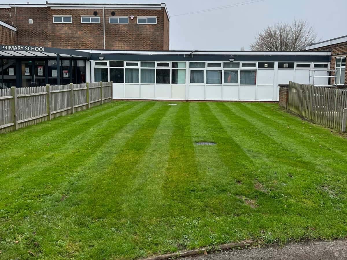 Striped lawn in front of a primary school